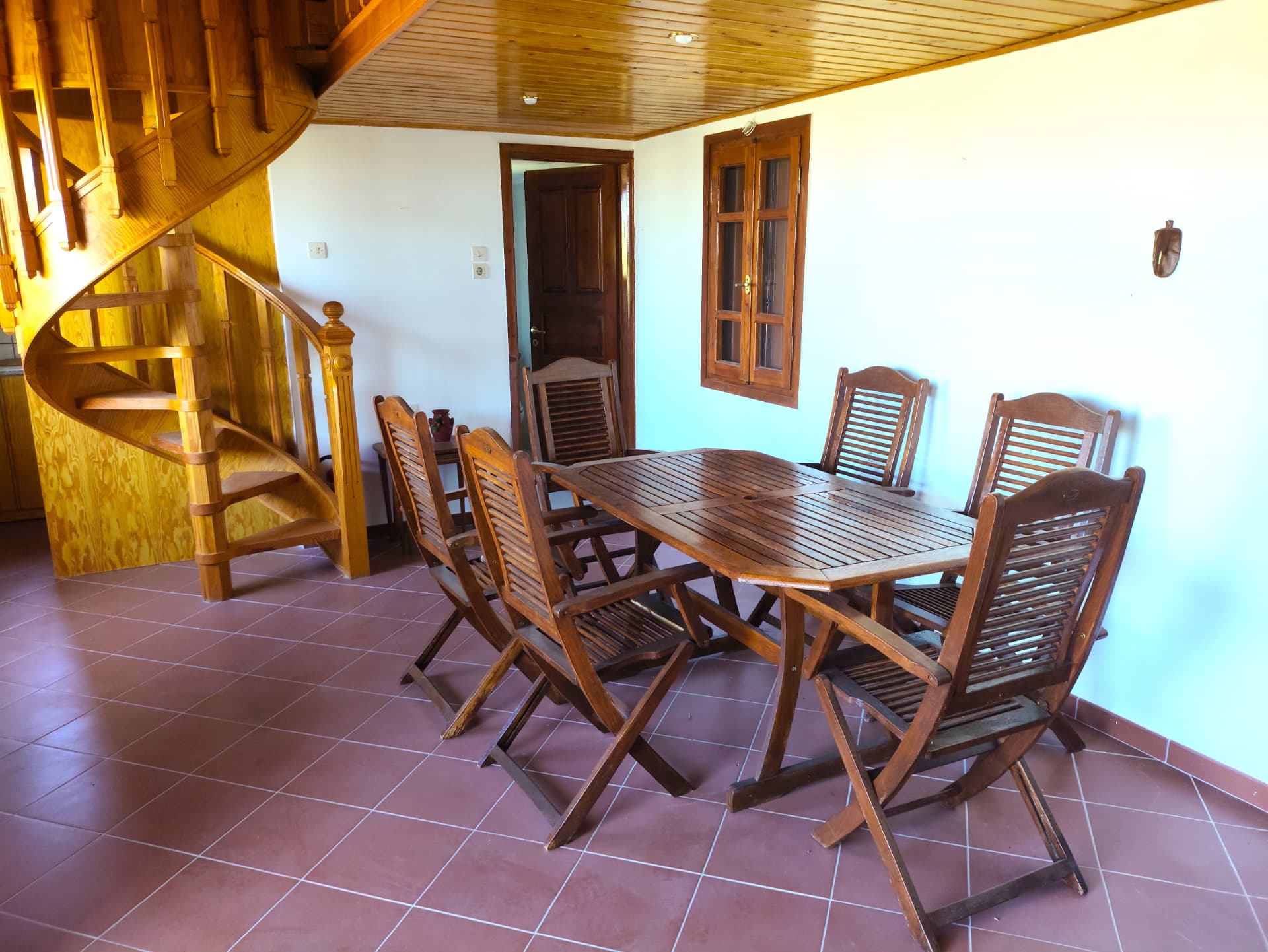 Dining table for six beneath the spiral staircase
