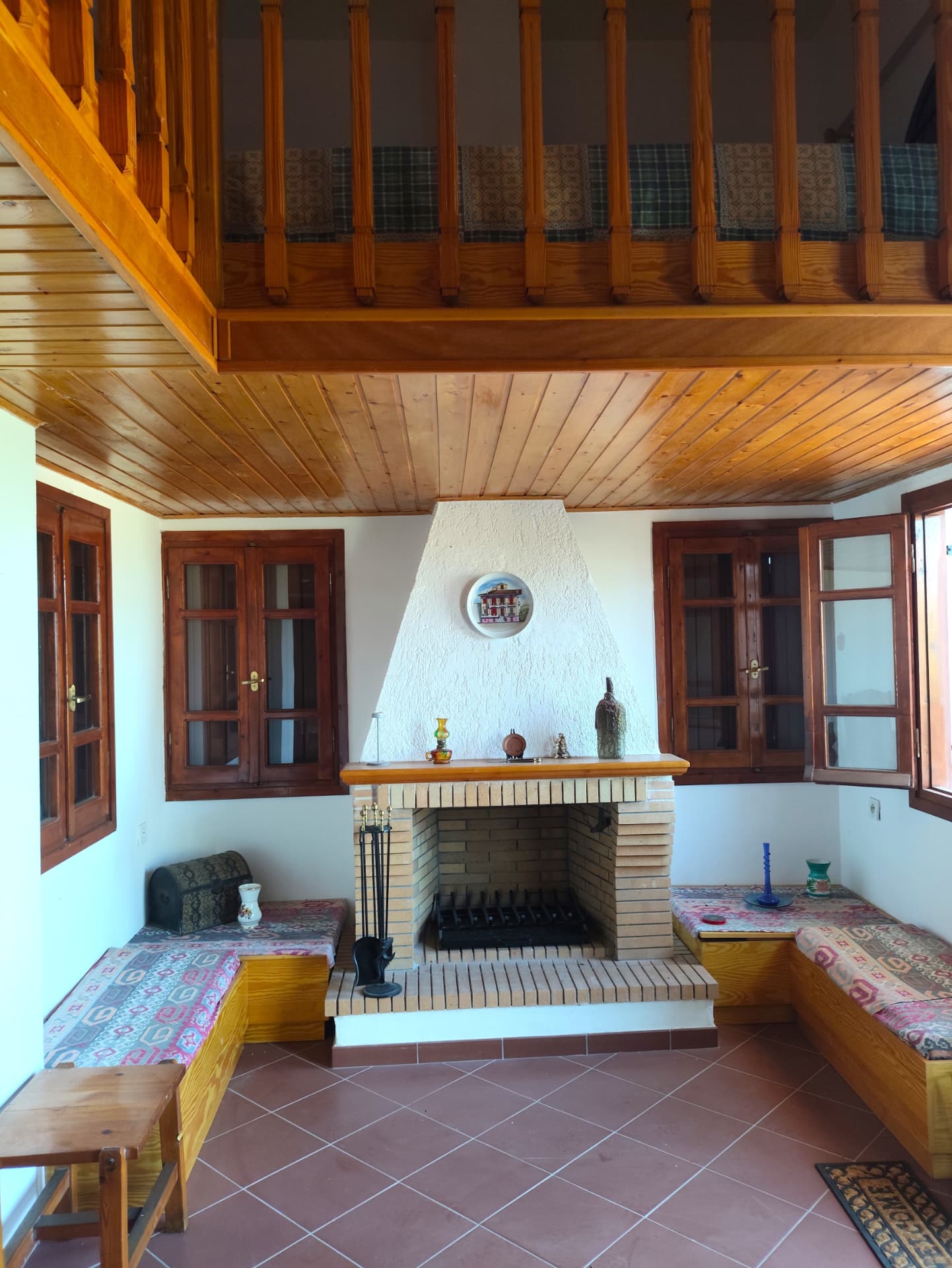 Living room with stone fireplace and wooden ceiling